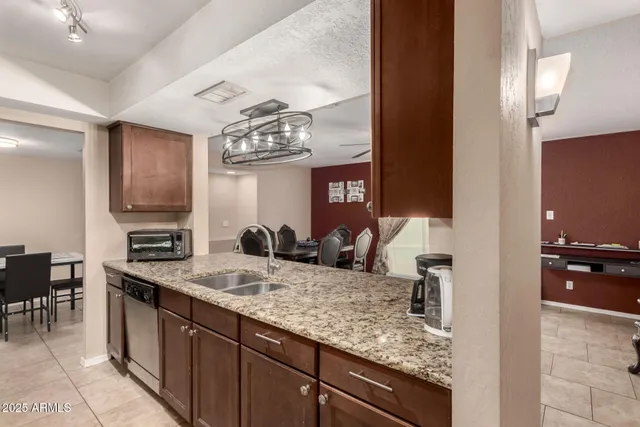a bathroom with a granite countertop sink a mirror and a vanity