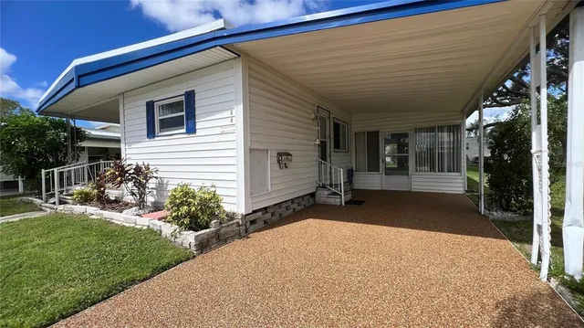a view of a backyard with plants and a patio