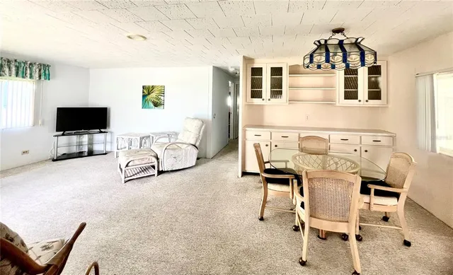 a kitchen with cabinets a refrigerator and a sink