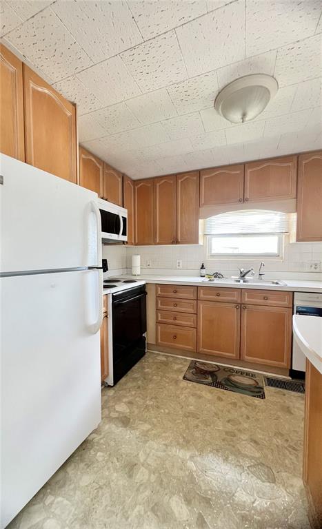1100 South Belcher Road, Unit 64 Largo, FL 33771 - Photo 14 of 52 a kitchen with a refrigerator and a sink