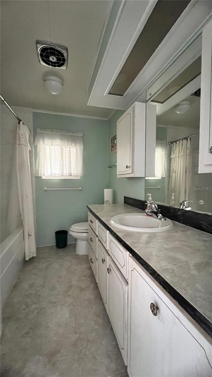 1100 South Belcher Road, Unit 64 Largo, FL 33771 - Photo 17 of 52 a bathroom with a granite countertop sink a toilet and a mirror