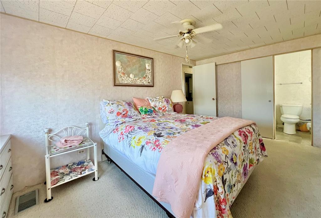 1100 South Belcher Road, Unit 64 Largo, FL 33771 - Photo 20 of 52 a bedroom with a bed and a chandelier