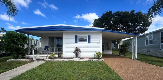 a front view of house with yard and outdoor seating
