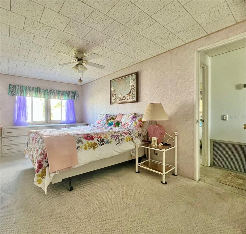 1100 South Belcher Road, Unit 64 Largo, FL 33771 - Photo 21 of 52 a bedroom with a bed and a chair
