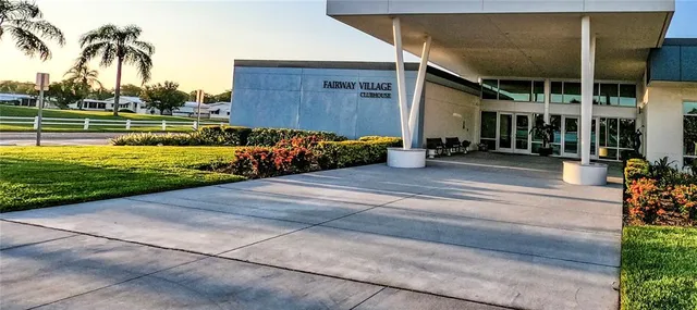 a view of a dining room with furniture a kitchen and chandelier