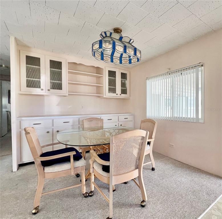 1100 South Belcher Road, Unit 64 Largo, FL 33771 - Photo 8 of 52 a dining room with furniture and window