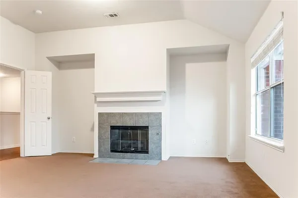 a view of an empty room with a fireplace