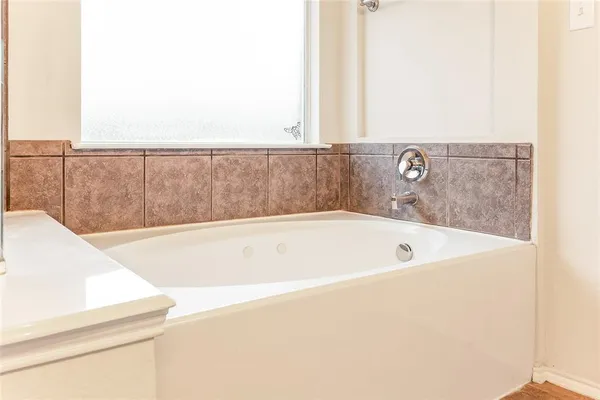 a bath tub sitting next to a white wall