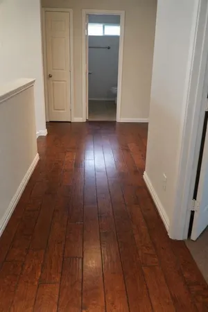 wooden floor in a hall with an empty room