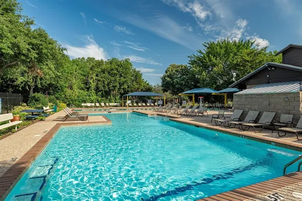 a swimming pool with outdoor seating and yard