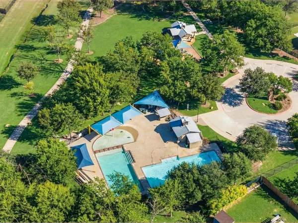 an aerial view of a house with a yard and lake view