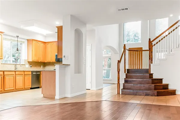 a view of a kitchen with wooden floor and electronic appliances