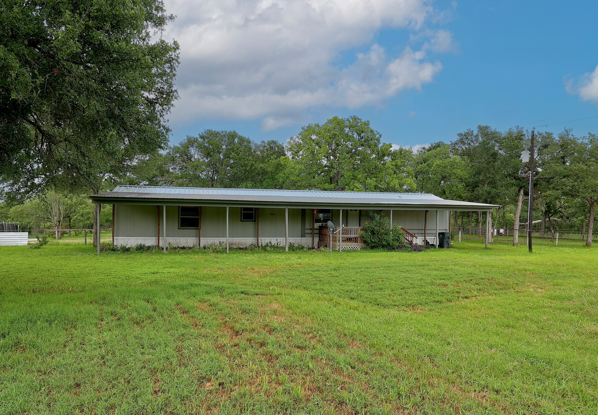 288 The Forest Road Dale, TX 78616 - Photo 3 of 31 a front view of a house with a garden
