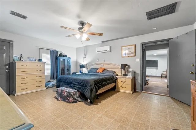 a spacious bedroom with a bed and a cabinets