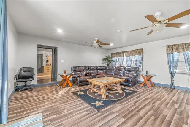 a living room with lots of furniture and a wooden floor