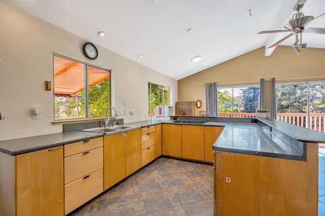 a kitchen with stainless steel appliances granite countertop a sink and a stove