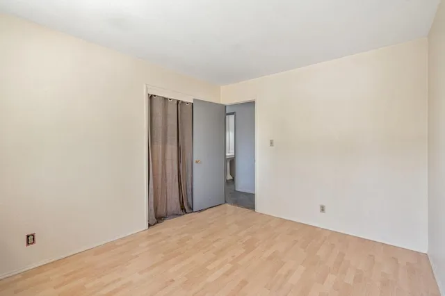 a view of a room with closet and wooden floor