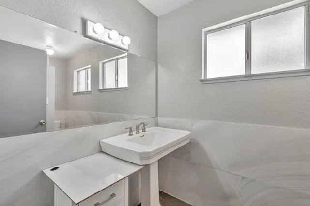 a bathroom with a sink and a mirror
