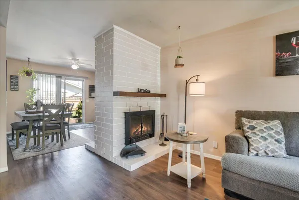 a living room with furniture a table and a fireplace