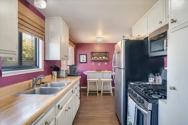 a kitchen with a sink stove and refrigerator