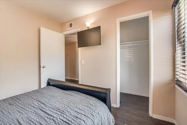 a bedroom with a bed and a flat screen tv
