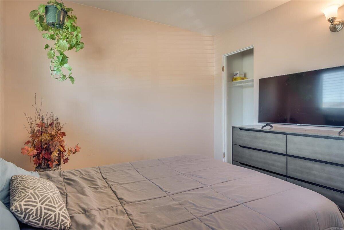 1601 Barrington Court Lompoc, CA 93436 - Photo 25 of 26 a bedroom with a bed and a potted plant