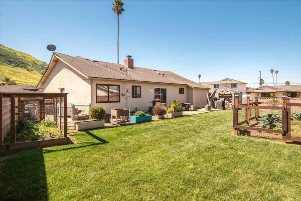 a view of a house with backyard porch and sitting area
