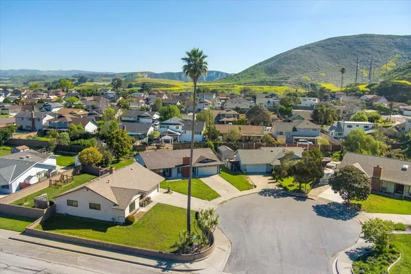 an aerial view of residential houses with outdoor space and swimming pool