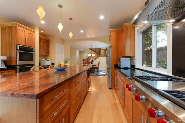 a kitchen with stainless steel appliances a sink stove and cabinets