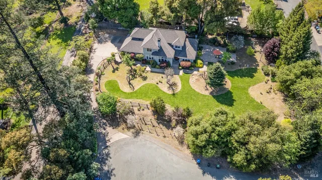 an aerial view of a house with a swimming pool