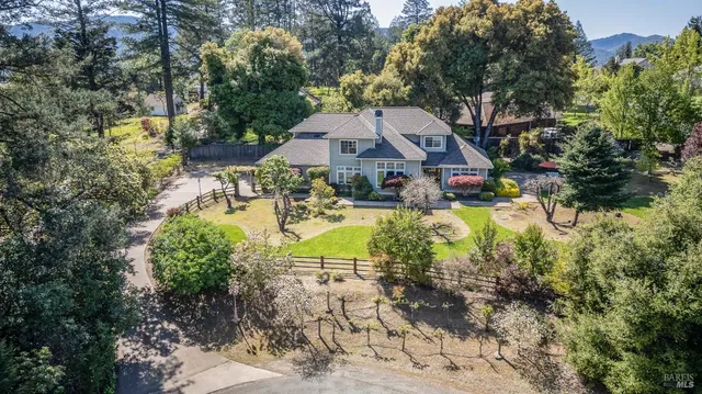 a view of a house with swimming pool and sitting area