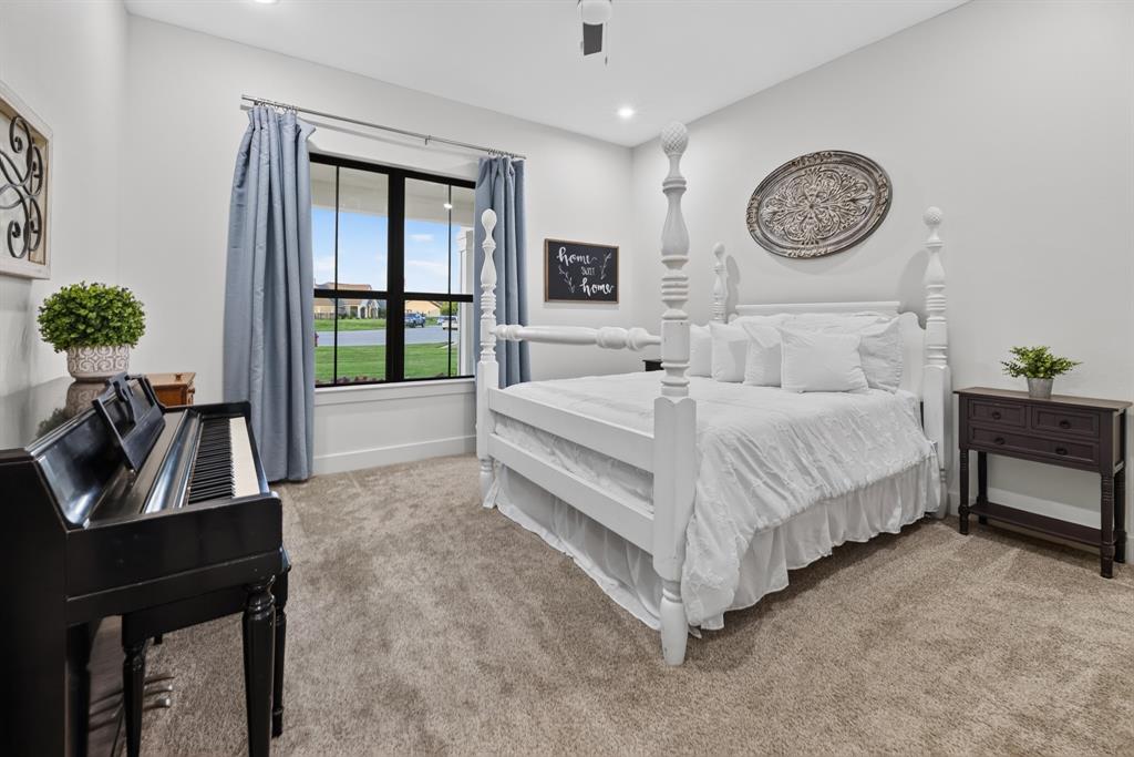 985 Vest Lane Pilot Point, TX 76258 - Photo 21 of 40 Recessed lighting illuminates this room featuring plush carpeting, a large window with white trim, and a ceiling fan