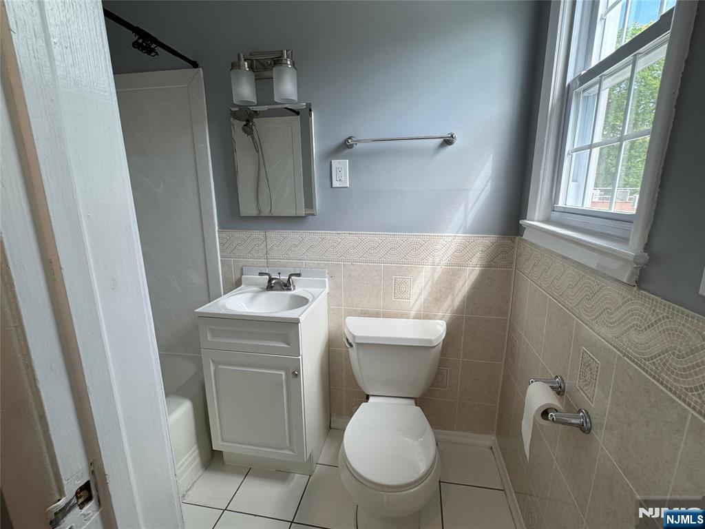 196-rock Rock Road, Unit 2A Glen Rock, NJ 07452 - Photo 21 of 26 a bathroom with a toilet sink and mirror