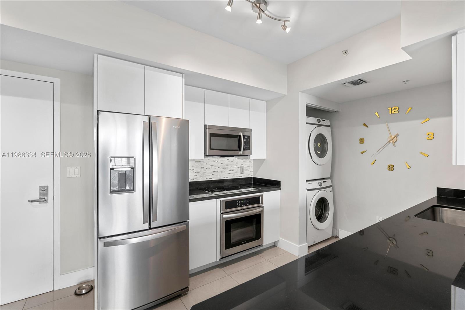 92 Southwest 3rd Street, Unit 4702 Miami, FL 33130 - Photo 11 of 47 a kitchen with stainless steel appliances a refrigerator a stove and white cabinets