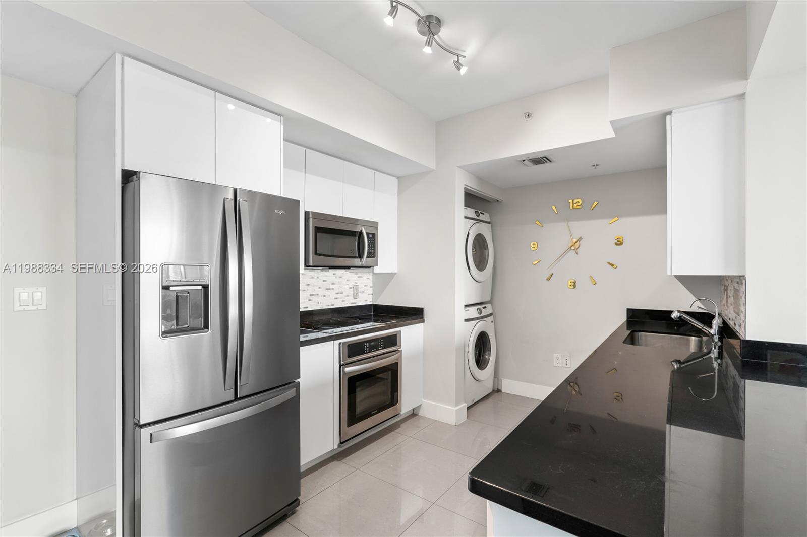 92 Southwest 3rd Street, Unit 4702 Miami, FL 33130 - Photo 13 of 47 a kitchen with granite countertop a refrigerator stove and sink