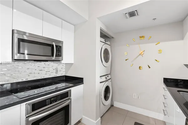 a kitchen with a microwave and a stove top oven