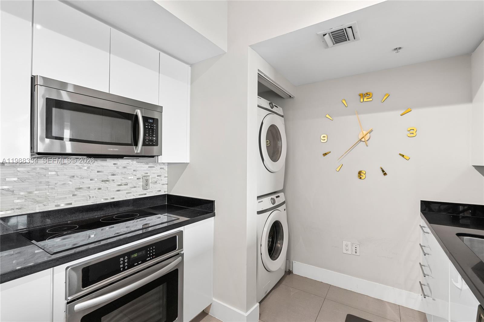 92 Southwest 3rd Street, Unit 4702 Miami, FL 33130 - Photo 14 of 47 a kitchen with a microwave and a stove top oven