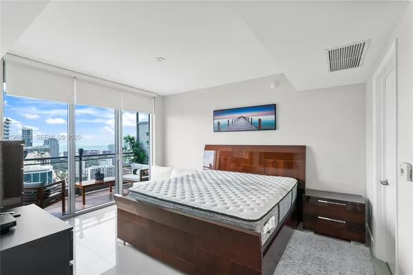 a living room with furniture rug and a large window
