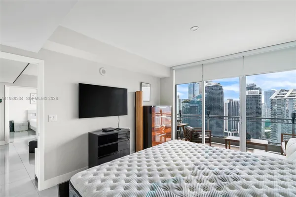 a bedroom with a bed and a flat screen tv