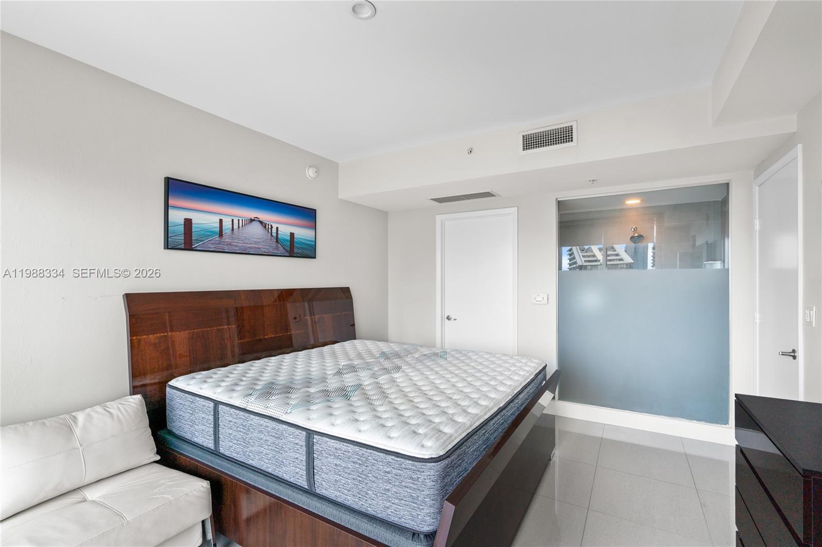 92 Southwest 3rd Street, Unit 4702 Miami, FL 33130 - Photo 21 of 47 a bedroom with a bed and a table in it