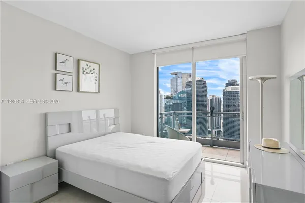 a bedroom with a large bed and a large window