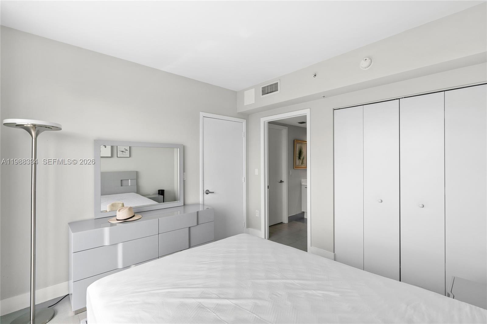 92 Southwest 3rd Street, Unit 4702 Miami, FL 33130 - Photo 26 of 47 a large white room with a double vanity sink and mirror