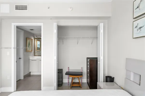 a living room with furniture and a mirror