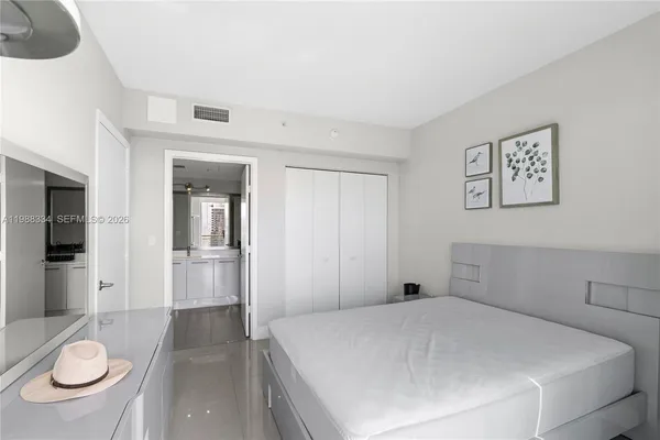 a bedroom with a bed and a dresser