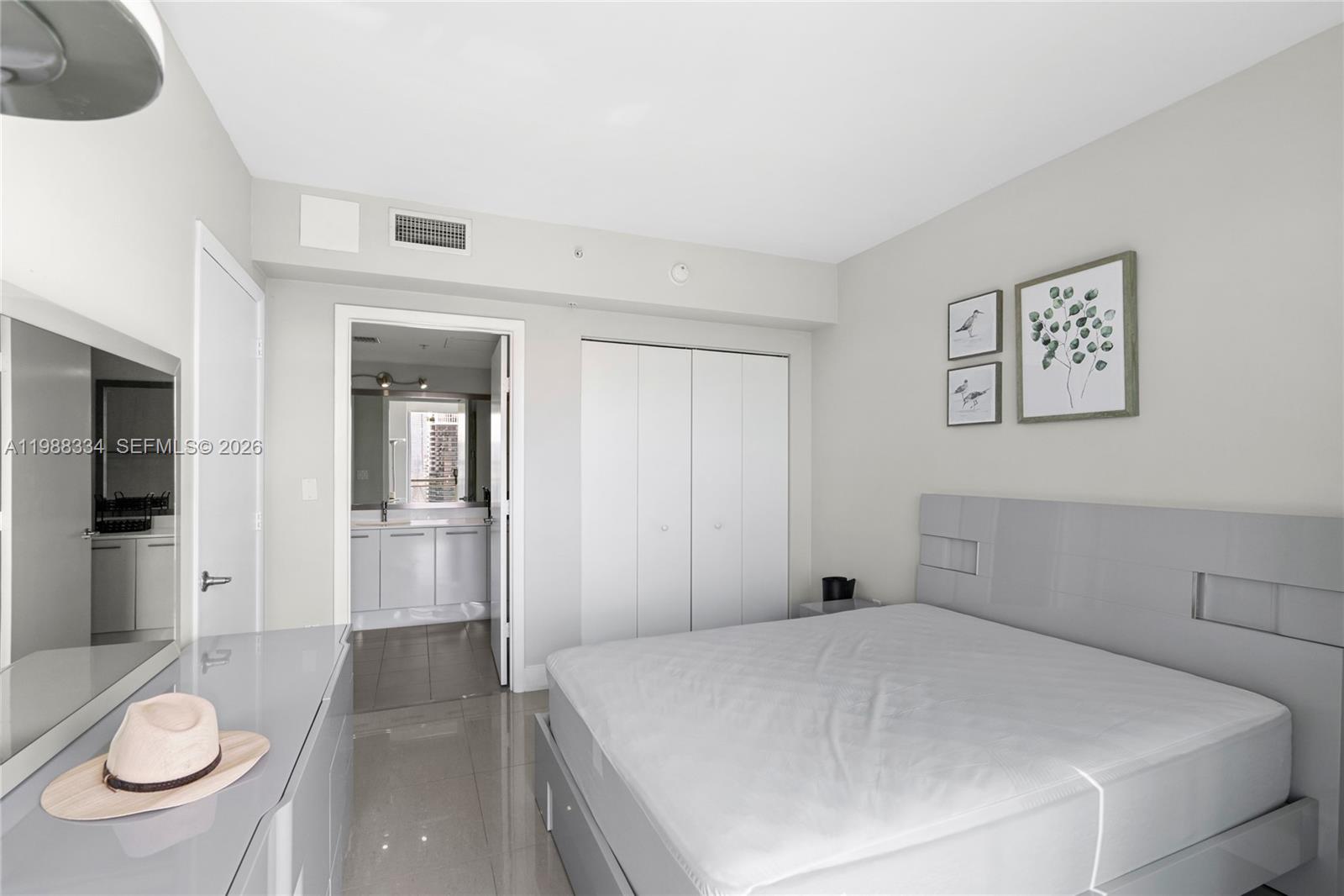 92 Southwest 3rd Street, Unit 4702 Miami, FL 33130 - Photo 28 of 47 a bedroom with a bed and a dresser