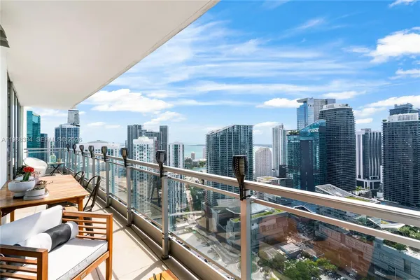 a view of a balcony with wooden floor and iron stairs