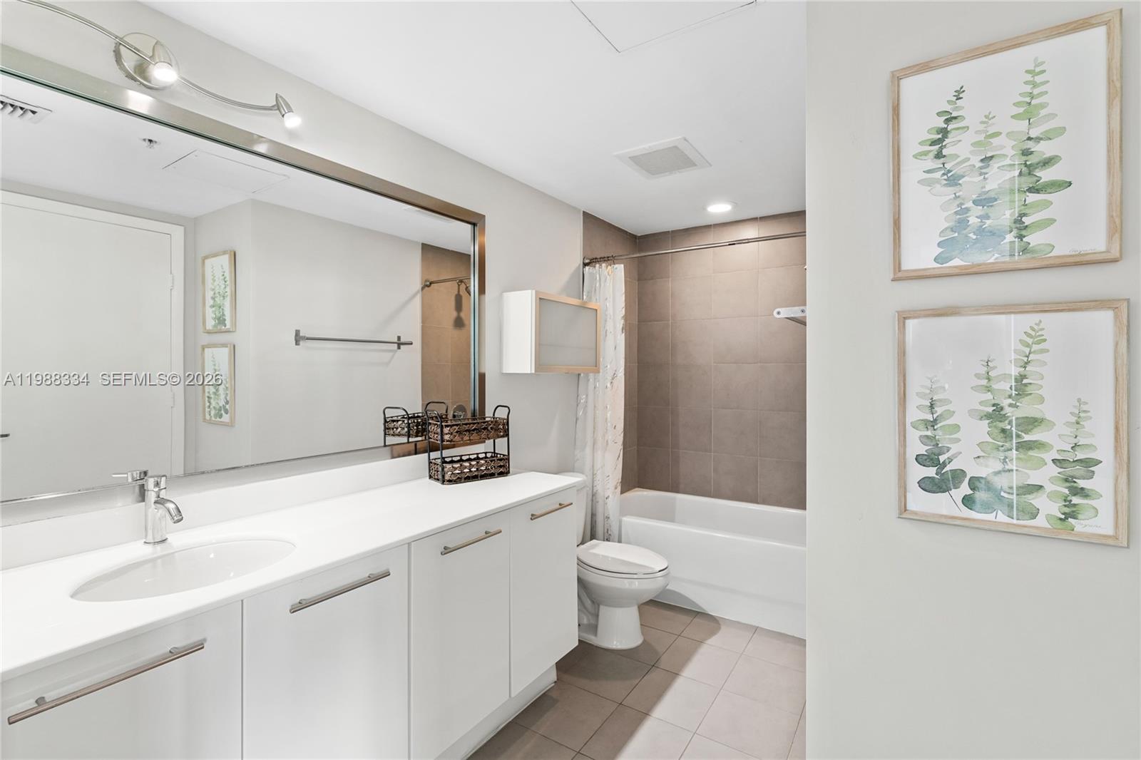 92 Southwest 3rd Street, Unit 4702 Miami, FL 33130 - Photo 42 of 47 a bathroom with a double vanity sink a toilet and a large mirror