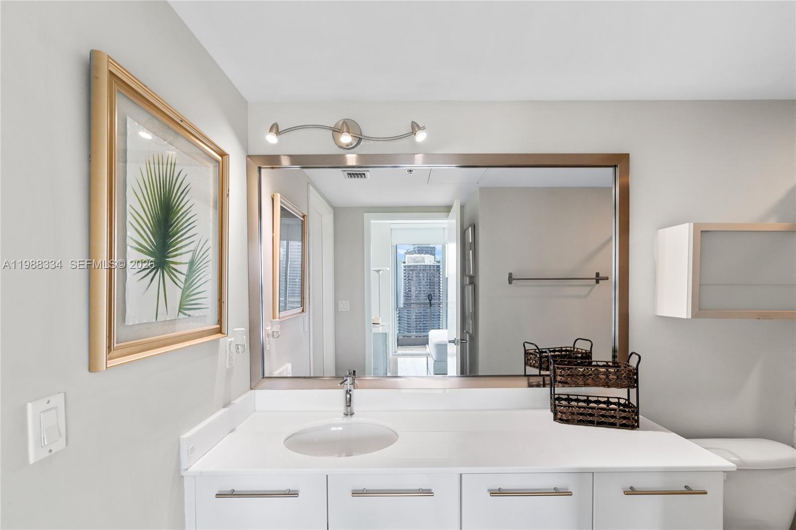92 Southwest 3rd Street, Unit 4702 Miami, FL 33130 - Photo 44 of 47 a bathroom with a sink a mirror and a window