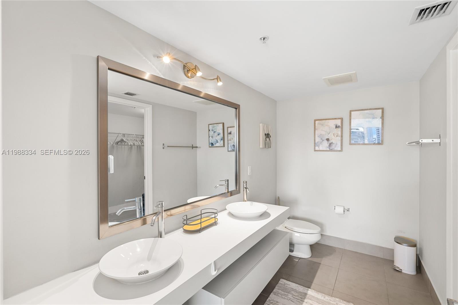 92 Southwest 3rd Street, Unit 4702 Miami, FL 33130 - Photo 45 of 47 a bathroom with a sink and a mirror