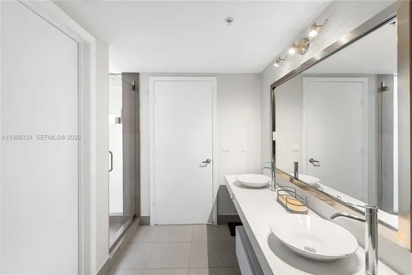 a bathroom with a glass shower door